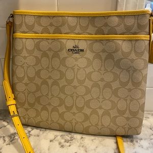 Coach original cross body signature bag with yellow accents.